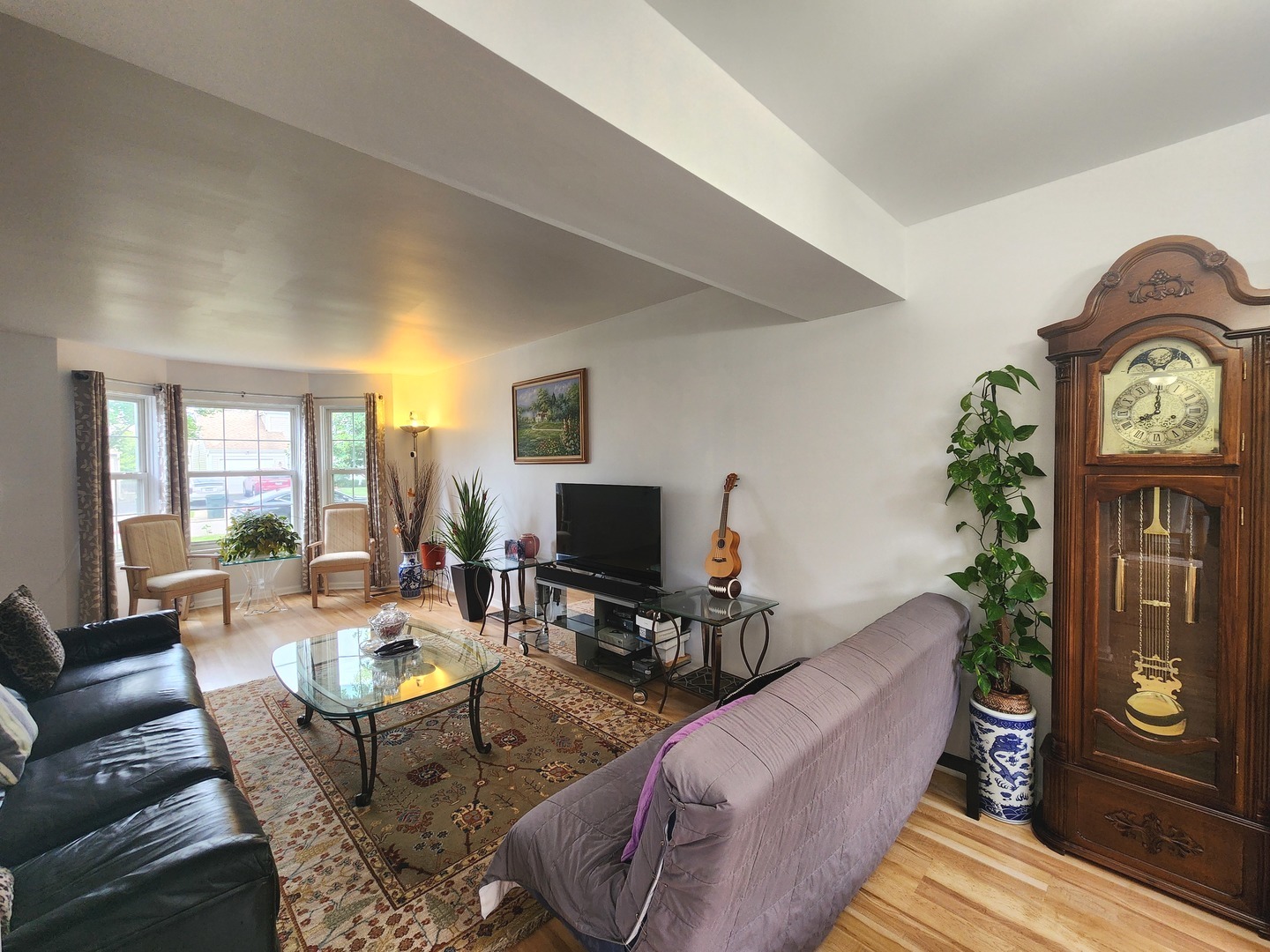 72 Wilton Lane Mundelein, IL 60060 - Photo 6 of 40 a living room with furniture a fireplace a flat screen tv and a large window