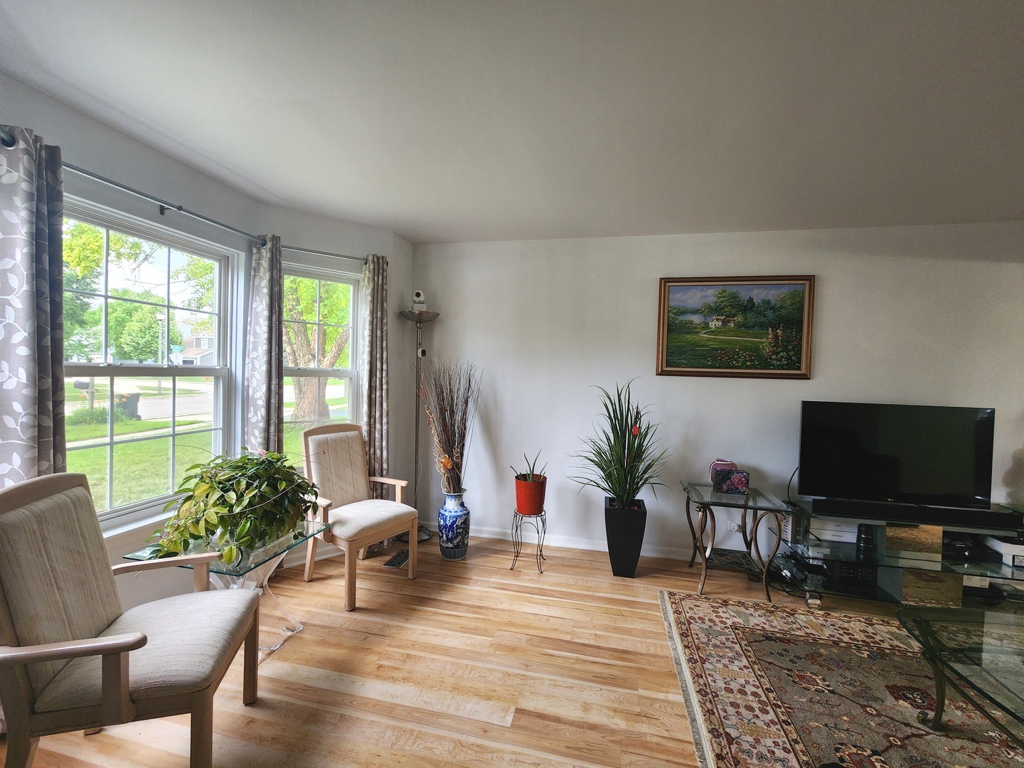 72 Wilton Lane Mundelein, IL 60060 - Photo 8 of 40 a living room with furniture a flat screen tv and a large window
