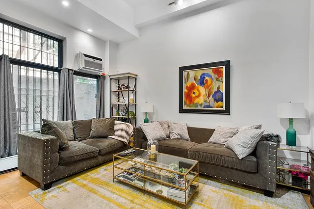 a living room with furniture and large window
