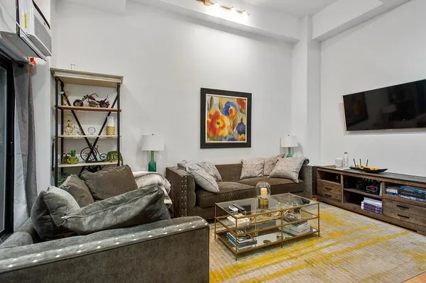 a living room with furniture and large window