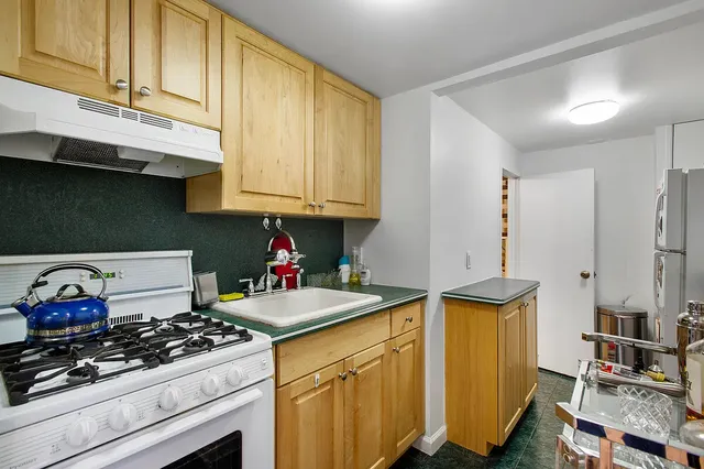 a bed sitting in a bedroom next to a lamp