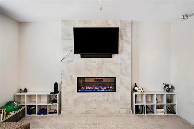 a living room with a fireplace and a flat screen tv