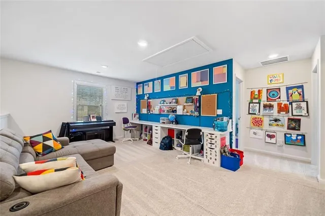 a view of play room with furniture and toys