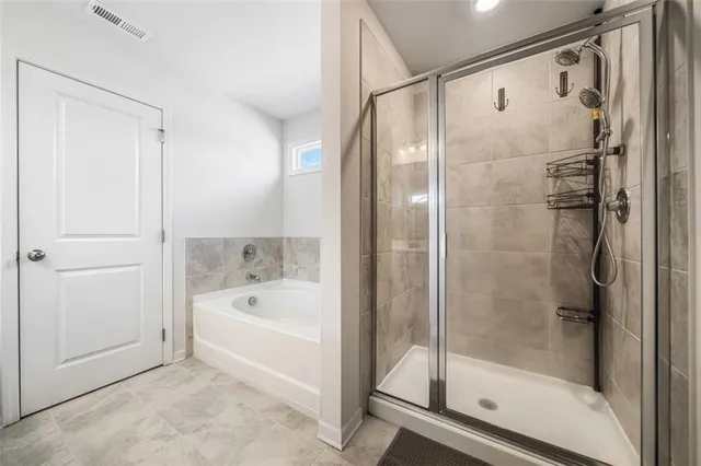 a bathroom with a bathtub and a shower