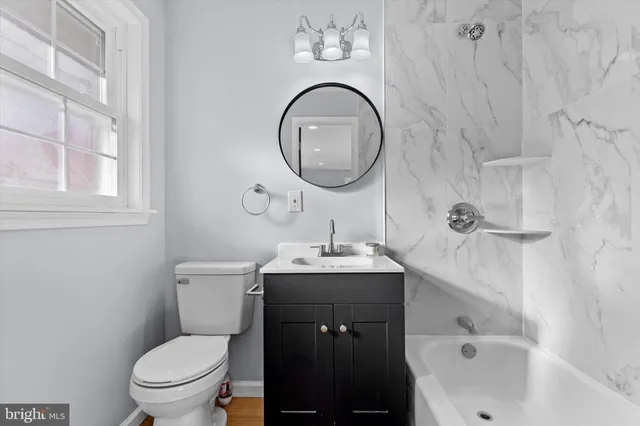 a bathroom with a sink a toilet and a mirror