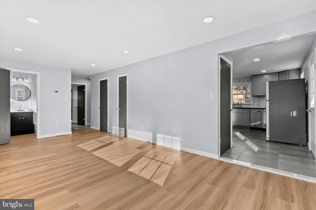 a view of a kitchen with a sink and a refrigerator