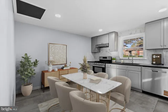 a kitchen with a table and chairs in it