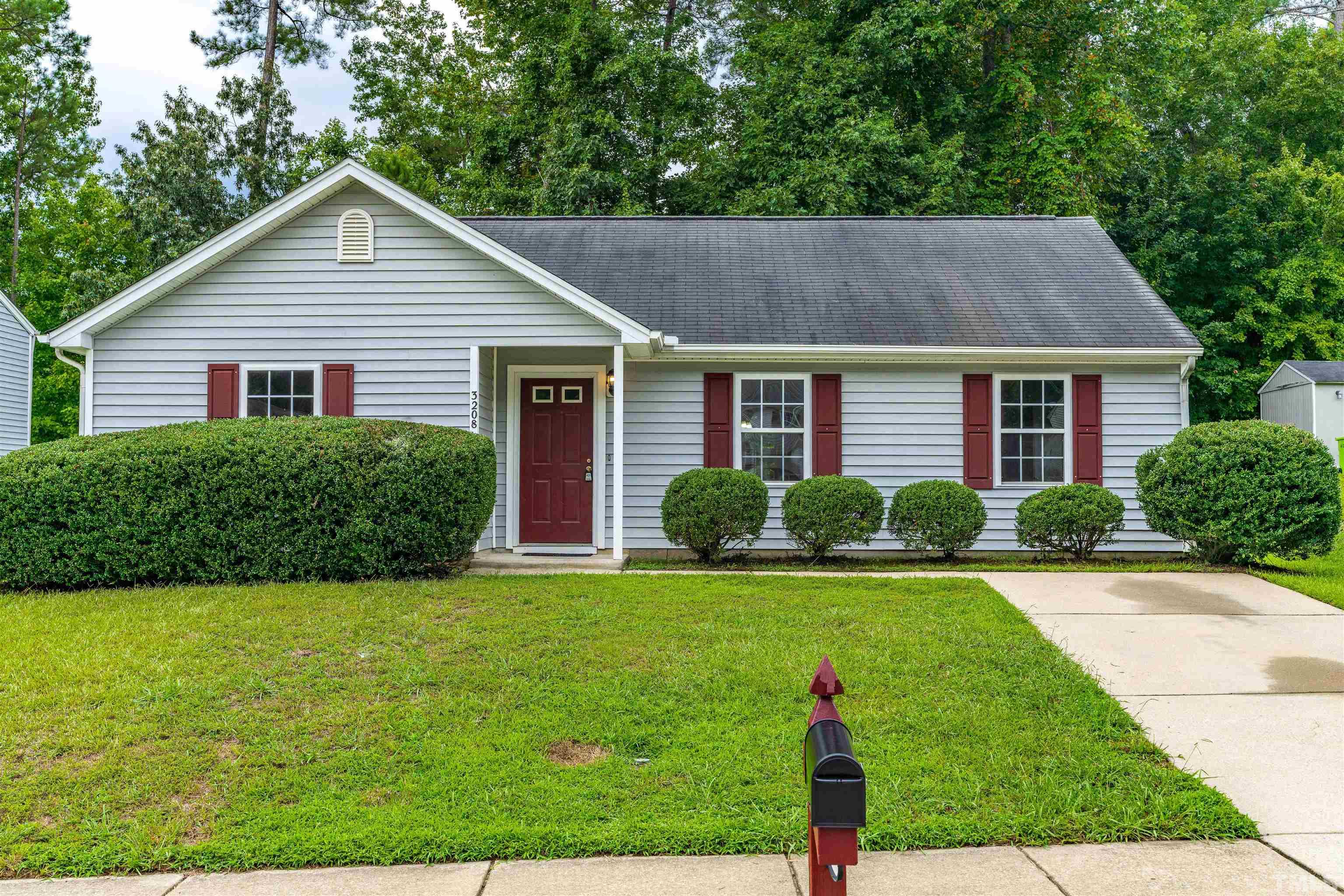 a front view of house with yard and green space