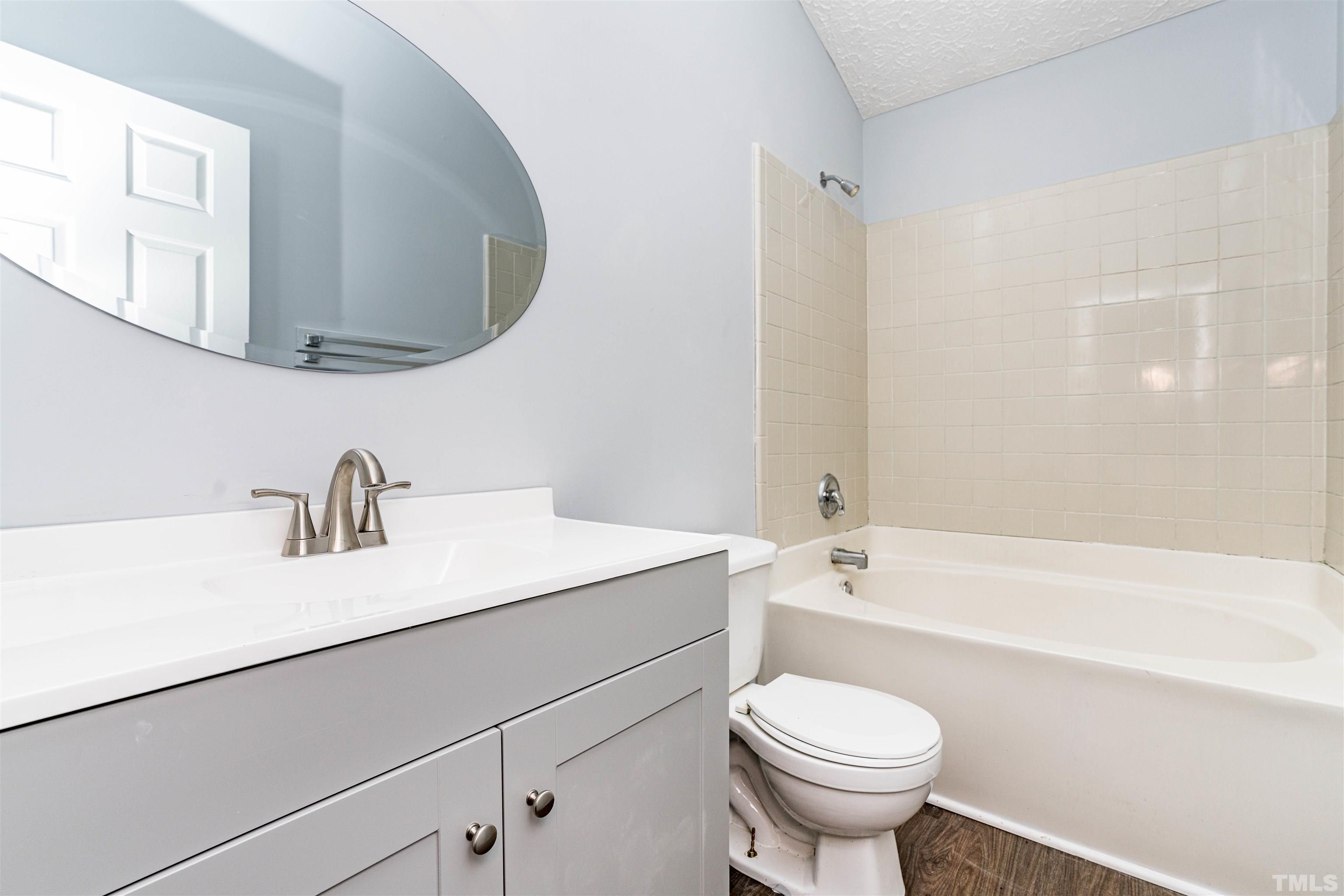 3208 Slippery Elm Drive Raleigh, NC 27610 - Photo 14 of 24 a bathroom with a sink a toilet and a bathtub