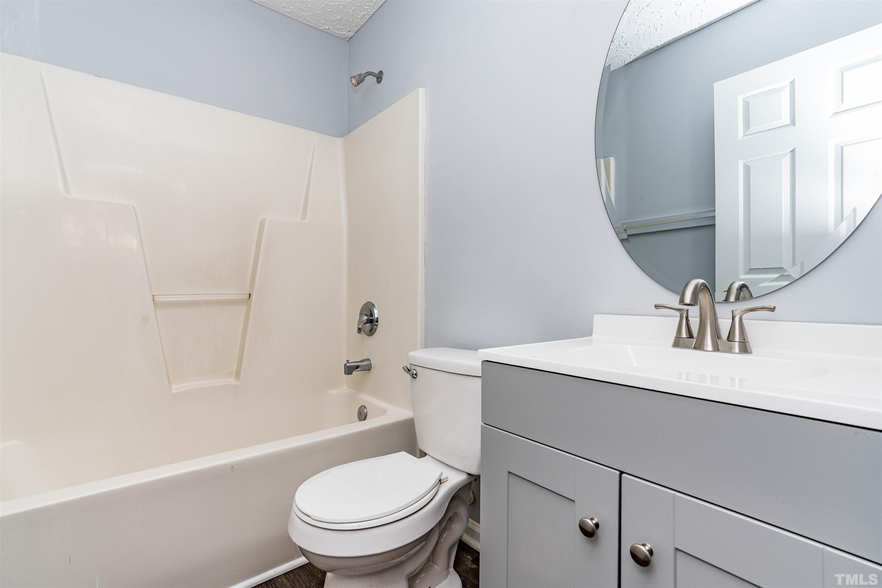 3208 Slippery Elm Drive Raleigh, NC 27610 - Photo 17 of 24 a bathroom with a sink toilet vanity and tub