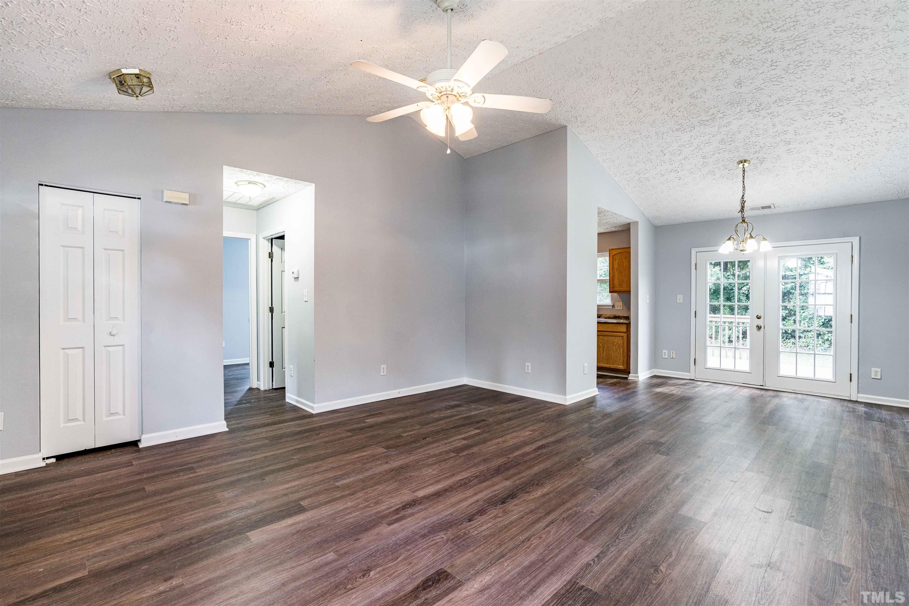 3208 Slippery Elm Drive Raleigh, NC 27610 - Photo 5 of 24 a view of an empty room with wooden floor and a window