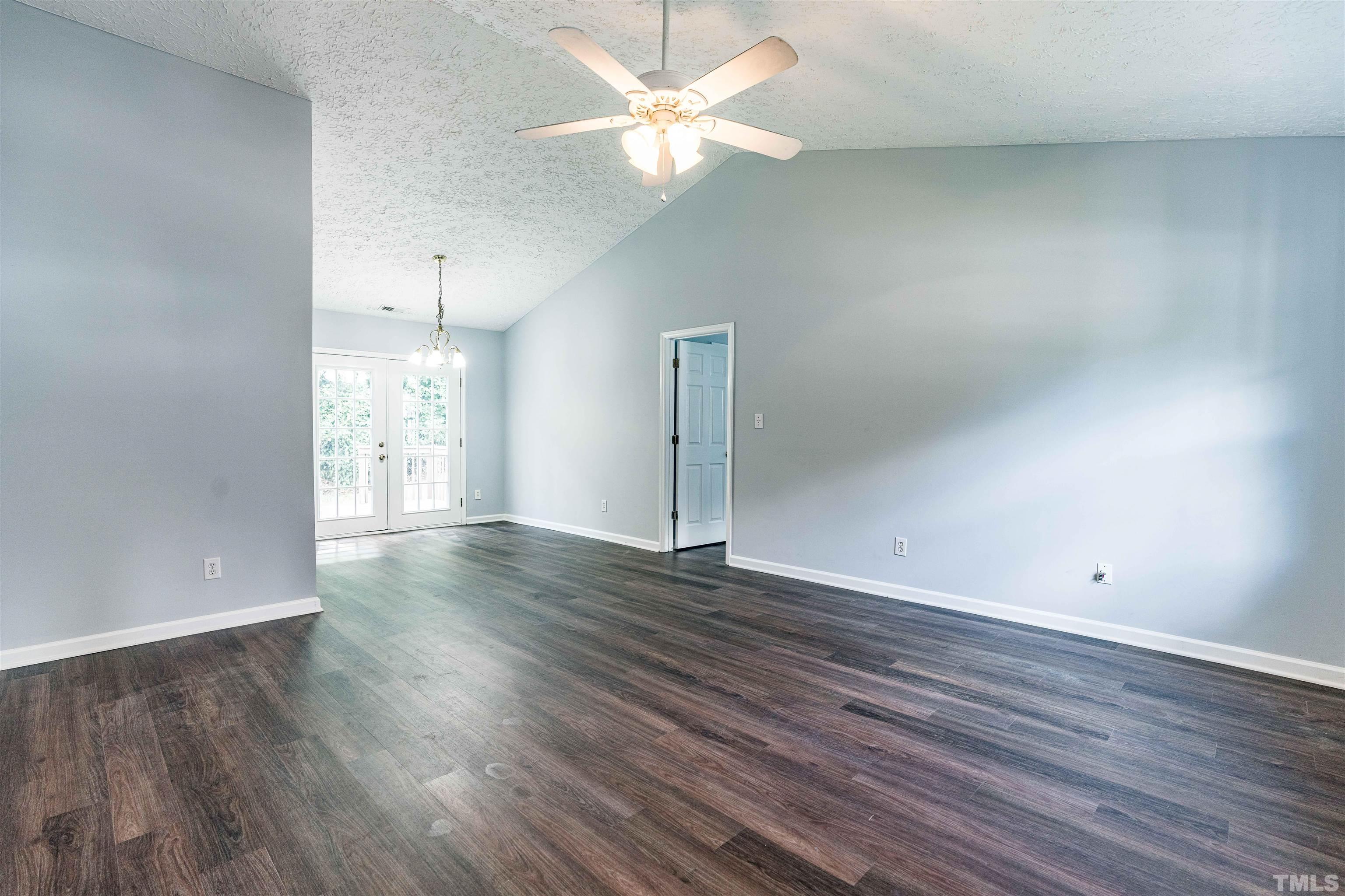 3208 Slippery Elm Drive Raleigh, NC 27610 - Photo 6 of 24 wooden floor in an empty room with a window