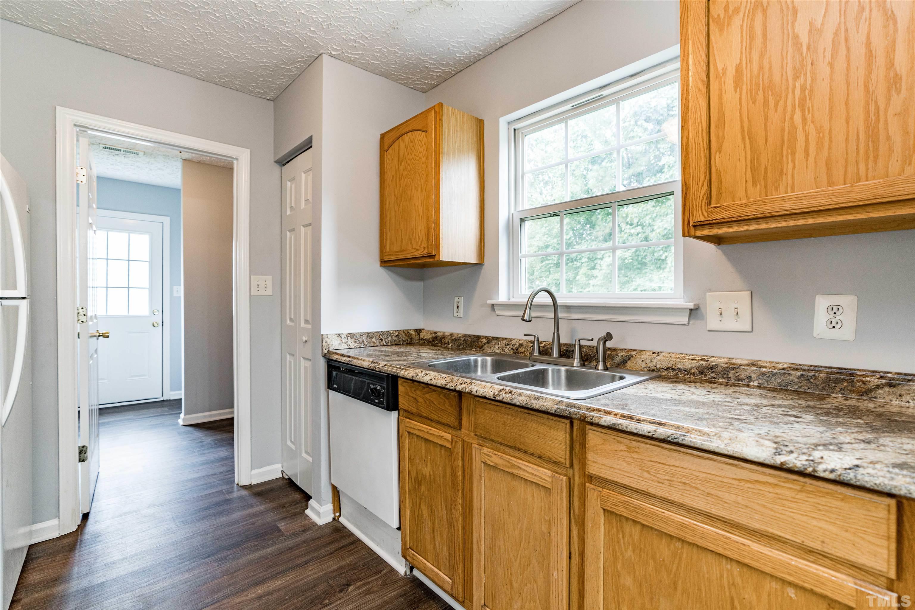 3208 Slippery Elm Drive Raleigh, NC 27610 - Photo 10 of 24 a kitchen with granite countertop wooden floors and sink