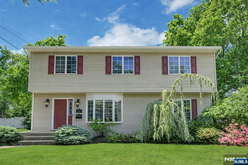 44 West Midland Avenue Paramus, NJ 07652 - Photo 1 of 19 front view of a house with a yard