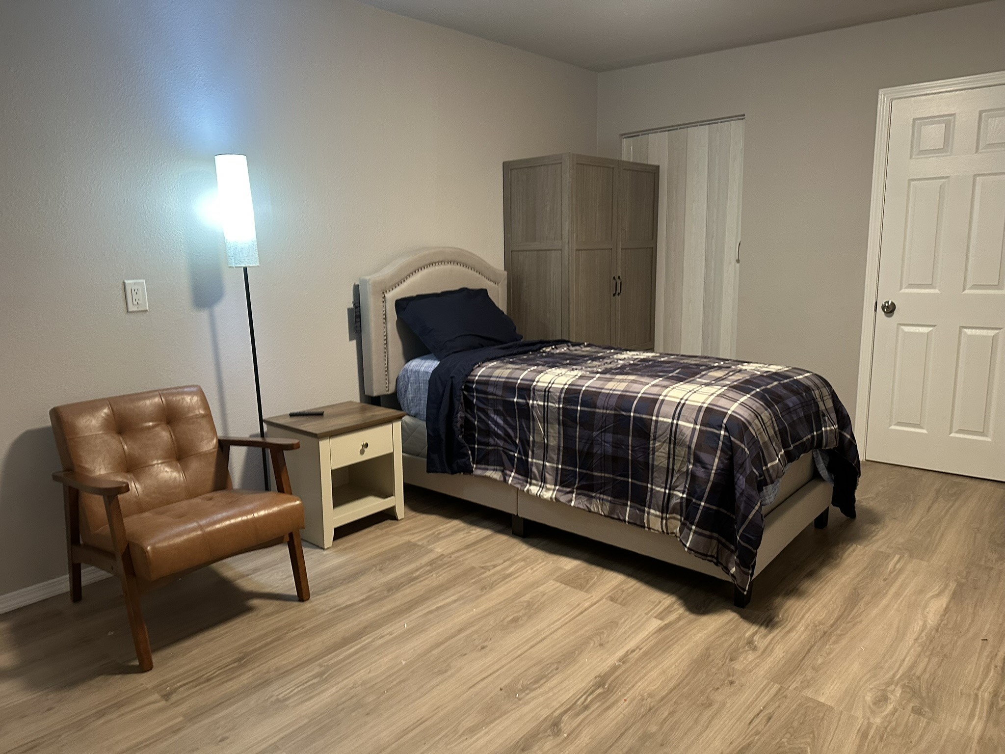 10811 Cranbrook Road Houston, TX 77042 - Photo 5 of 10 a bedroom with a bed a chair and dresser