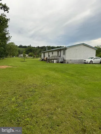 a view of a big house with a big yard
