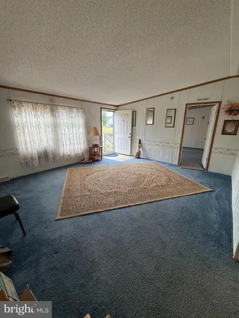 a large bedroom with a bed and window