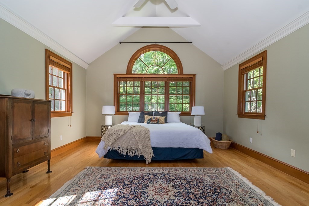 21 Cunningham Road Wellesley, MA 02481 - Photo 12 of 23 a spacious bedroom with a bed a chandelier and a window