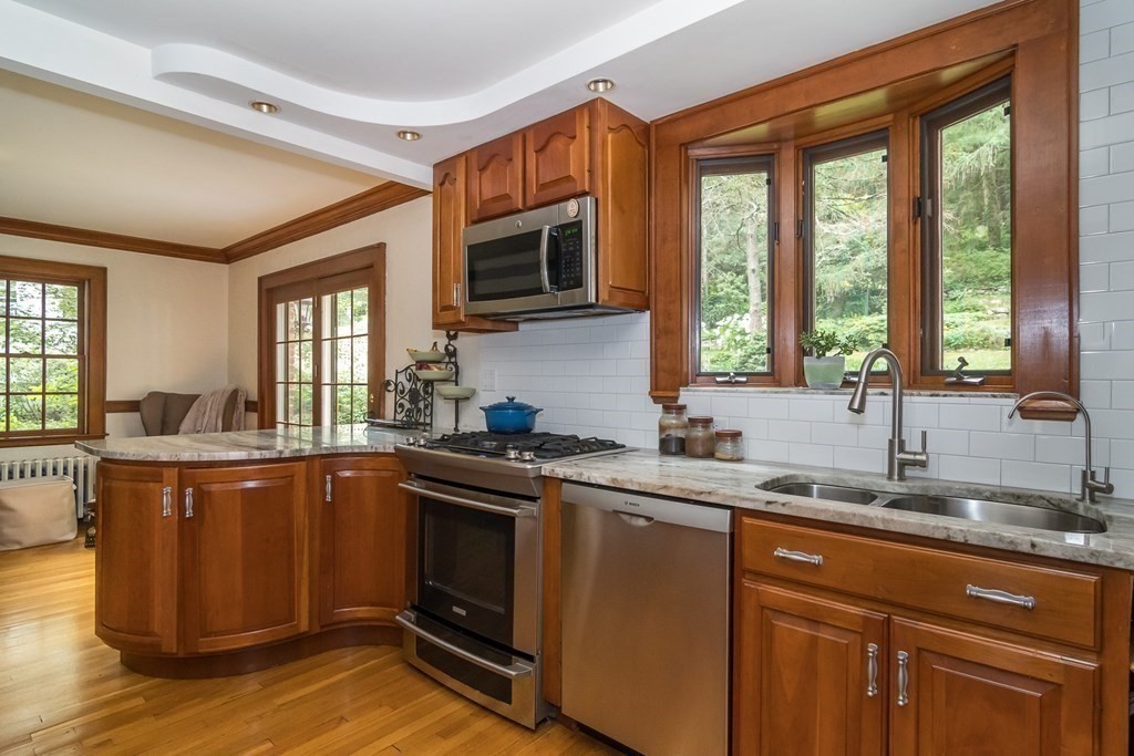 21 Cunningham Road Wellesley, MA 02481 - Photo 7 of 23 a kitchen with stainless steel appliances granite countertop a sink stove and microwave