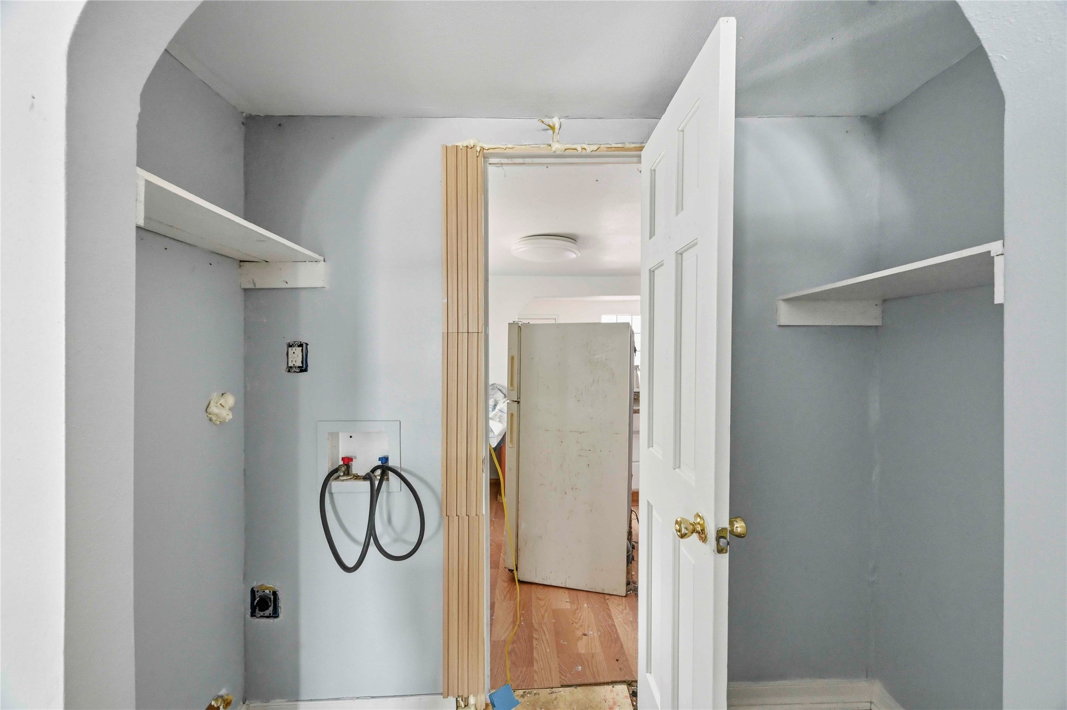 5513 Makeig Street Houston, TX 77026 - Photo 11 of 33 A dedicated utility space with built in shelving and a functional layout, offering convenient storage and easy access to nearby rooms.