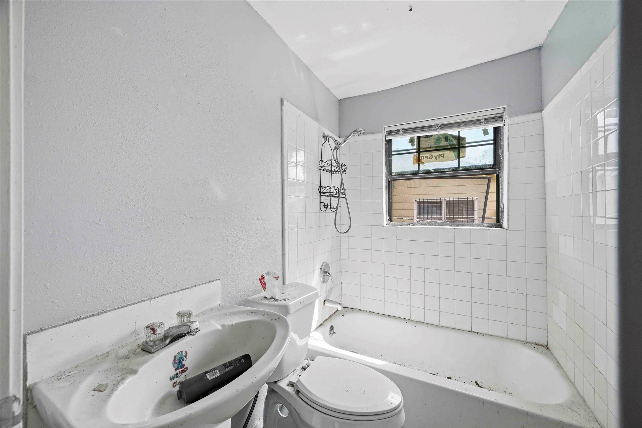 5513 Makeig Street Houston, TX 77026 - Photo 14 of 33 This bathroom features a practical layout with a bathtub and shower combination, a window for natural light, and a functional design ready for your personal touch.