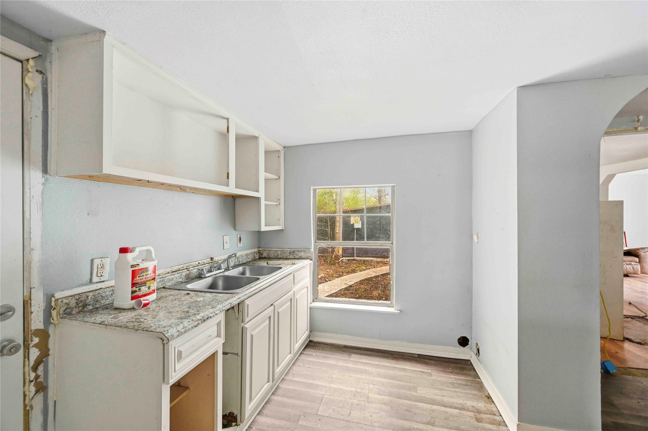 5513 Makeig Street Houston, TX 77026 - Photo 18 of 33 This kitchen features a double sink, a window overlooking the yard, and a functional layout with great potential for updates and customization.