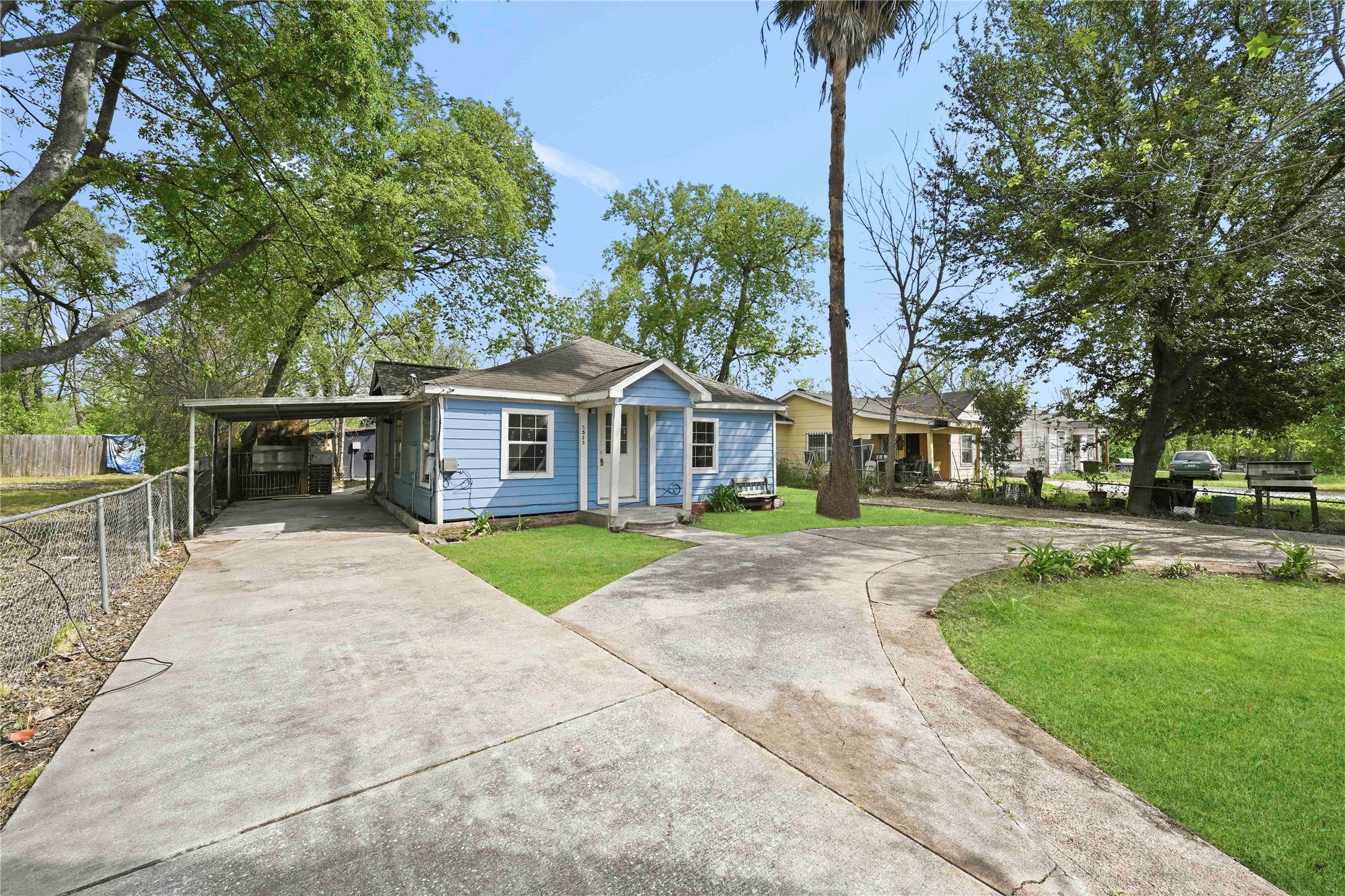 5513 Makeig Street Houston, TX 77026 - Photo 2 of 33 Nestled among mature trees, this charming blue cottage offers a peaceful retreat with a cozy front porch, spacious yard, and paved driveway. A place where simple moments feel special and every day feels a little more relaxed.