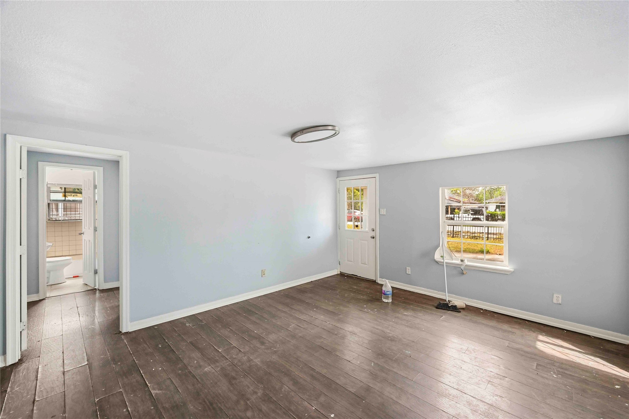 5513 Makeig Street Houston, TX 77026 - Photo 24 of 33 A bright and versatile room with natural light, a functional layout, and convenient access to the outside and nearby rooms.