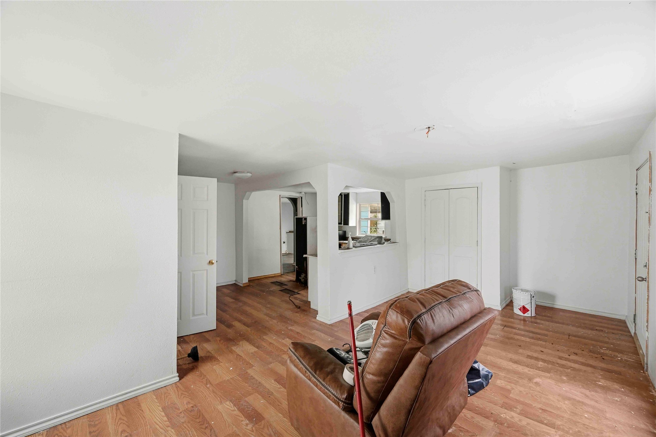 5513 Makeig Street Houston, TX 77026 - Photo 7 of 33 Bright and open living space with light wood flooring and soft natural light. The clean, simple layout and open connection to the kitchen create a warm and welcoming atmosphere ready for your personal touch.