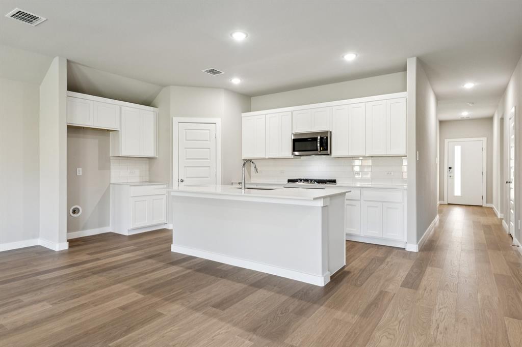 1404 Barbacoa Drive Haslet, TX 76052 - Photo 6 of 32 Kitchen in the Emmy II home plan by Trophy Signature Homes - REPRESENTATIVE PHOTO