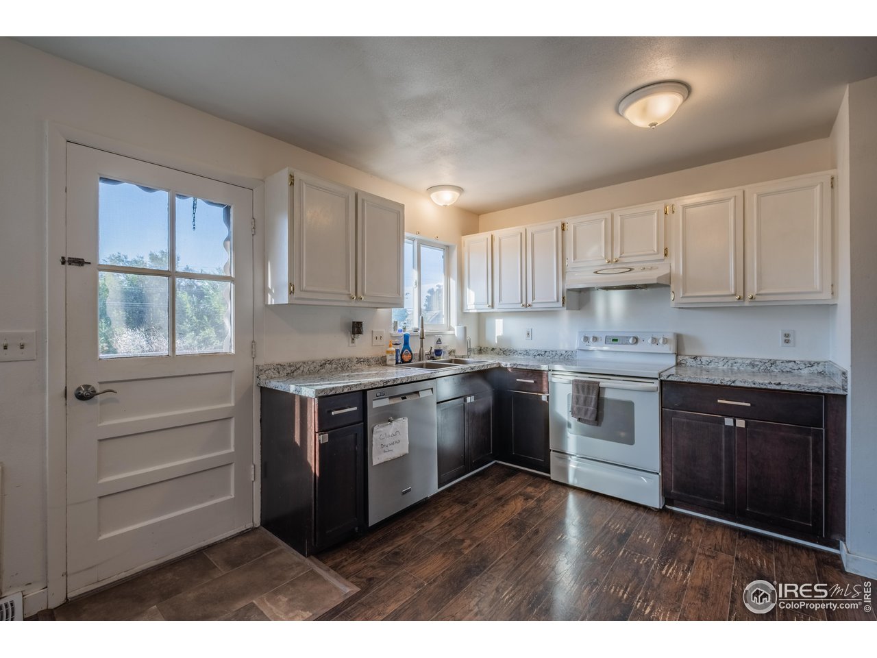 1602 29th Avenue Greeley, CO 80634 - Photo 4 of 18 a kitchen with granite countertop a stove top oven sink and cabinets