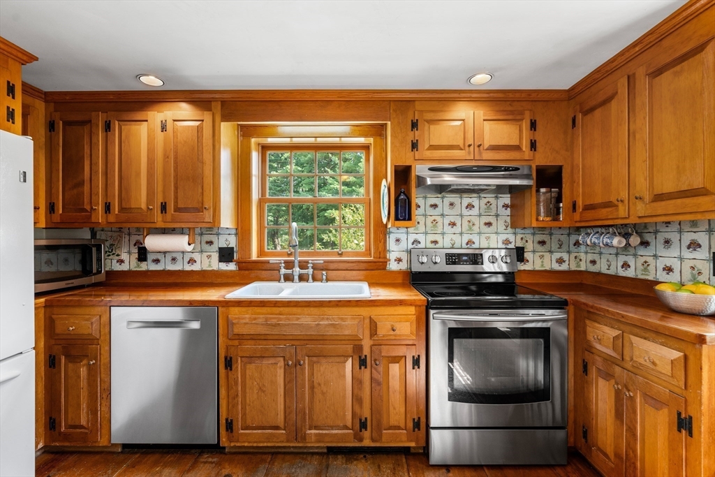 84 Hopestill Brown Road Sudbury, MA 01776 - Photo 13 of 42 a kitchen with stainless steel appliances granite countertop a stove a sink and a microwave