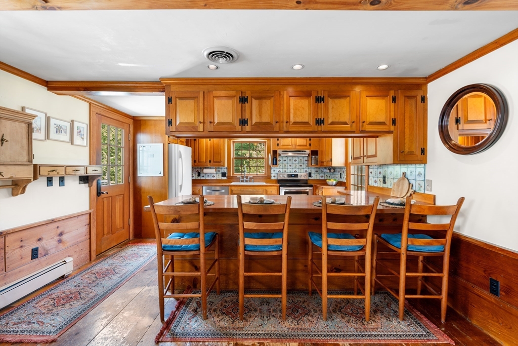 84 Hopestill Brown Road Sudbury, MA 01776 - Photo 14 of 42 a dining room with furniture a rug and a chandelier
