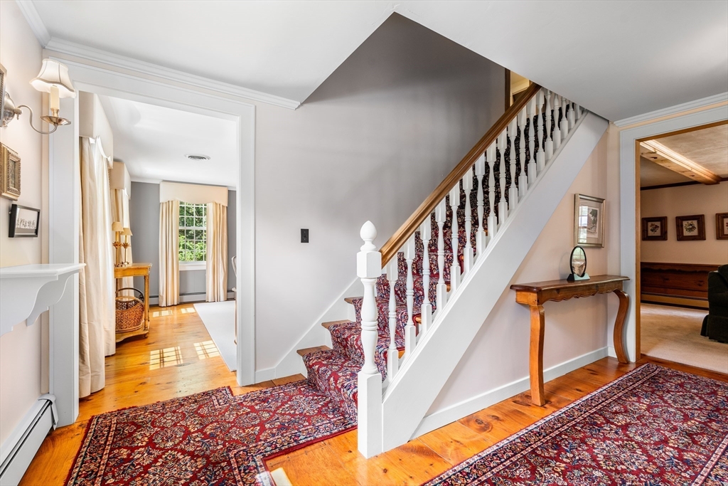 84 Hopestill Brown Road Sudbury, MA 01776 - Photo 22 of 42 a view of a hallway with wooden floor and staircase