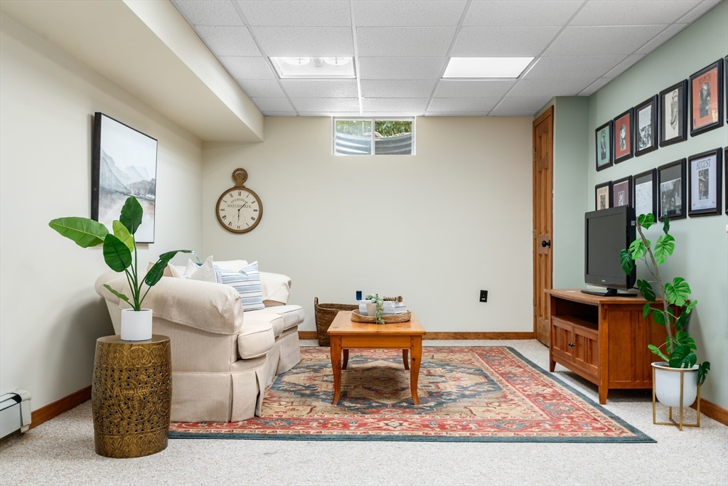 84 Hopestill Brown Road Sudbury, MA 01776 - Photo 28 of 42 a living room with furniture and a potted plant