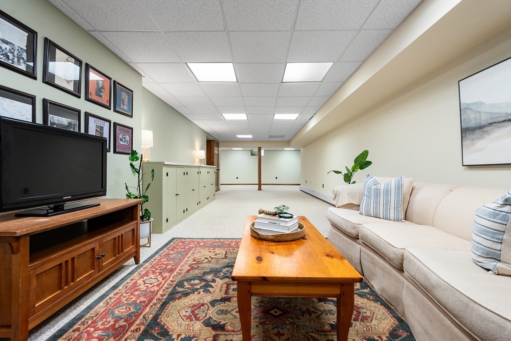 84 Hopestill Brown Road Sudbury, MA 01776 - Photo 29 of 42 a living room with furniture and a flat screen tv