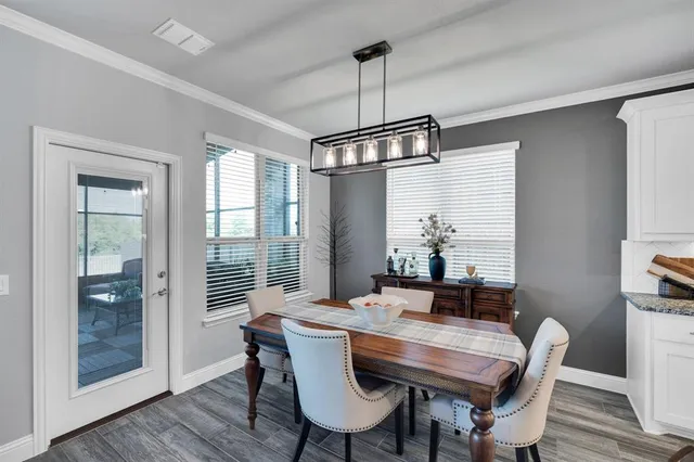 a dining room with furniture window and wooden floor