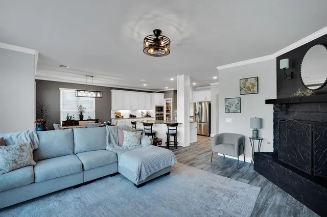 a living room with furniture a fireplace and a flat screen tv