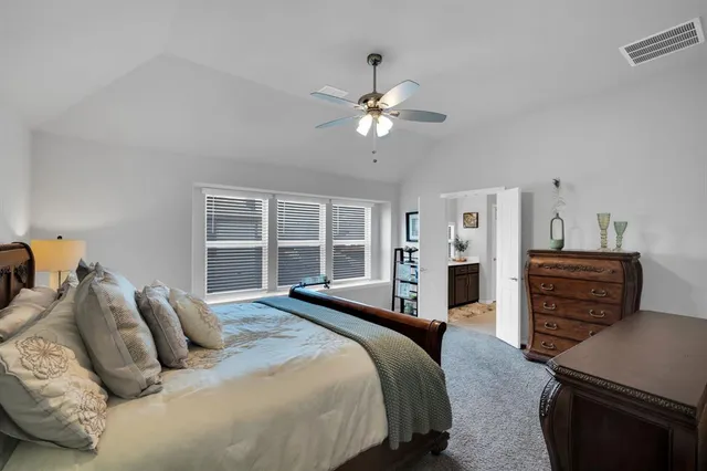 a bedroom with a bed dresser and a window