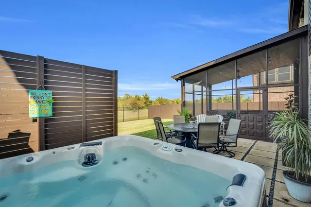 a balcony with table and chairs