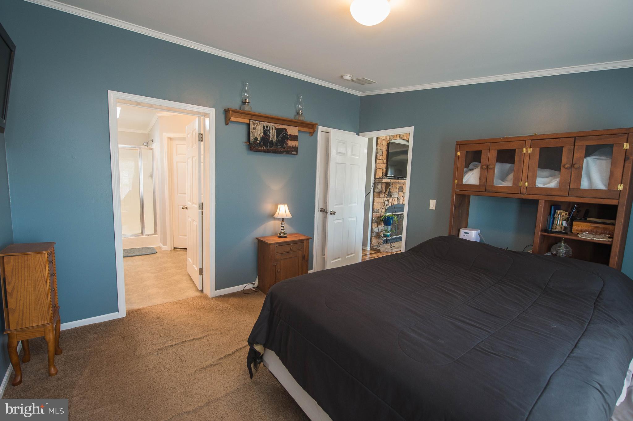 36388 Poplar Neck Road Willards, MD 21874 - Photo 19 of 34 a bedroom with a bed and a cabinets
