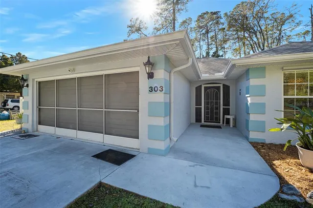a view of a house with backyard sitting area and garden