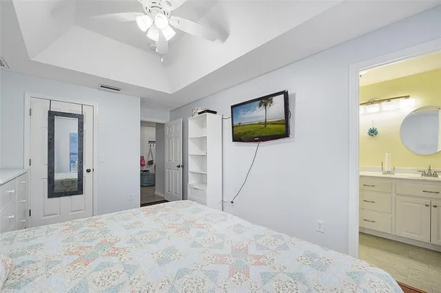 a bedroom with a large bed and a chandelier