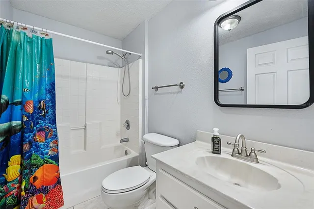 a bathroom with a sink mirror vanity and toilet