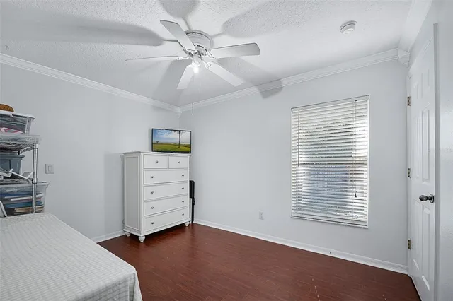 a view of a bedroom with furniture and wooden floor