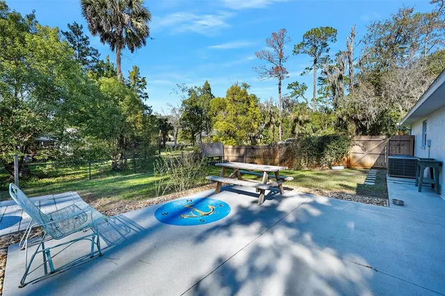 a view of backyard with wooden fence and a slide