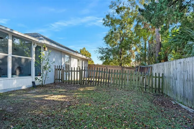 a view of a house with backyard and sitting area