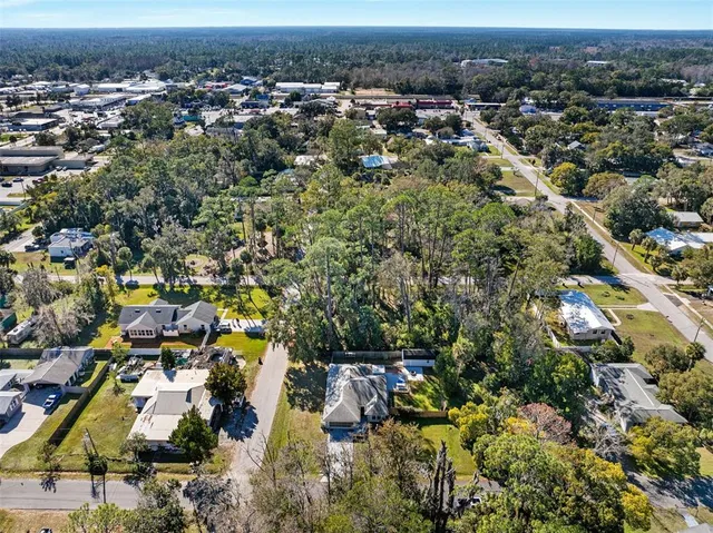 an aerial view of residential houses with outdoor space