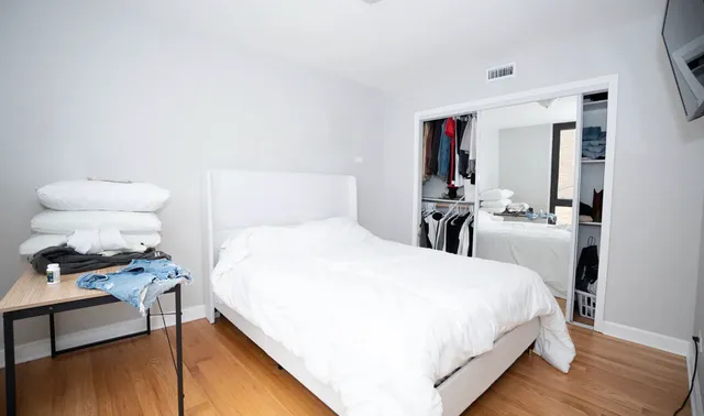 a bedroom with a bed and a table in it