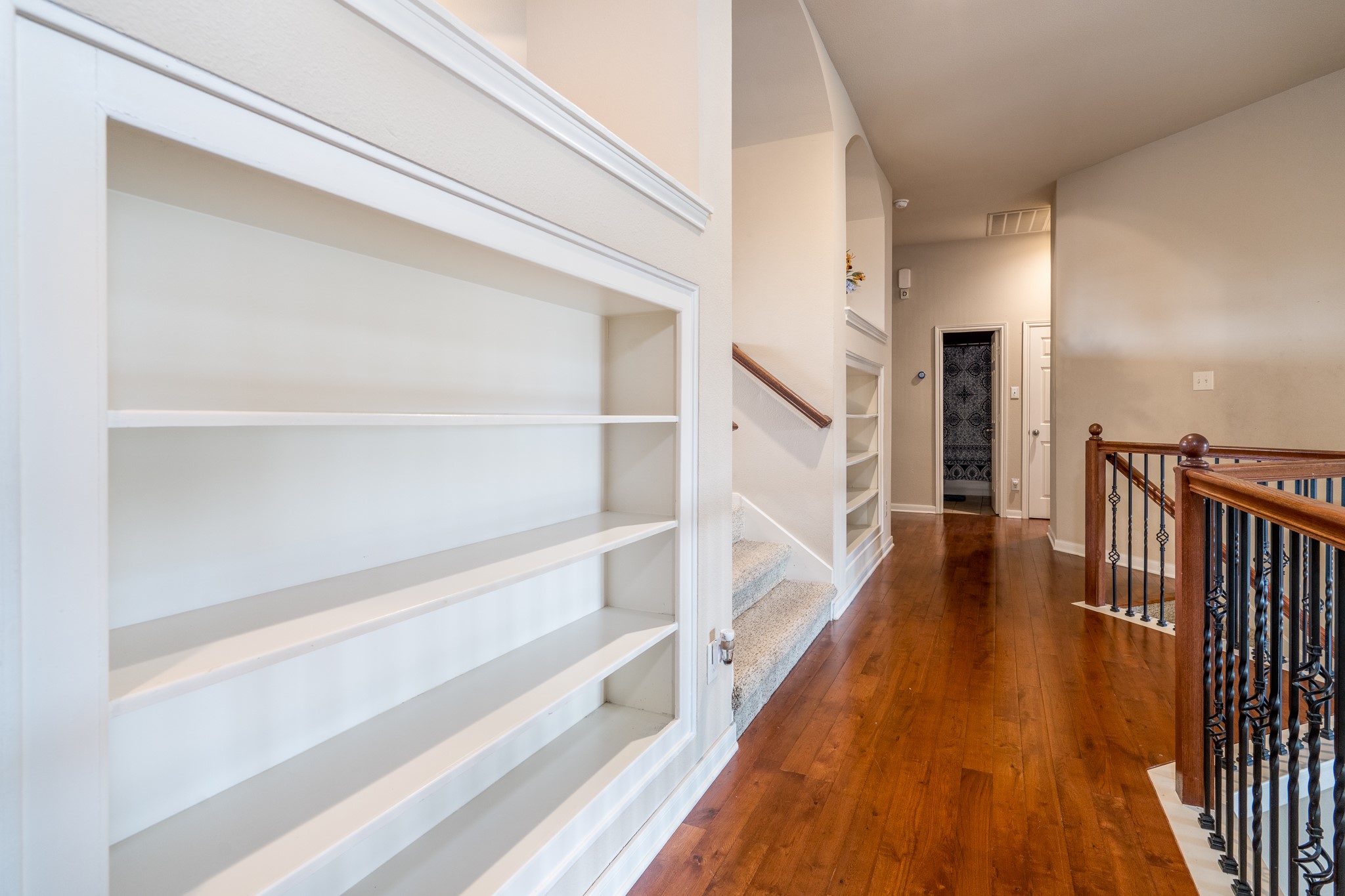 907 Colorado Springs Court Spring, TX 77373 - Photo 23 of 34 Built-in display shelves add character and practical storage and don't miss the wood flooring.